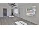 Bright living room featuring gray flooring, a ceiling fan, and a large window at 1303 E New Orleans Ave, Tampa, FL 33603