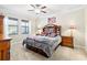 Main bedroom with a large bed, wooden furniture, and plenty of natural light at 13634 Ashlar Slate Pl, Riverview, FL 33579