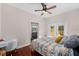 Main bedroom with hardwood floors, en suite bathroom, and ceiling fan at 1402 N Gordon St, Plant City, FL 33563