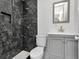 Bathroom featuring a stylish black marble tiled shower and gray vanity at 1405 Nance Ave, Tampa, FL 33606