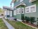 Exterior side view showing the siding, trim and a small porch with stairs to the yard at 1405 Nance Ave, Tampa, FL 33606