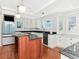 Bright kitchen featuring a center island, stainless steel appliances, and white cabinetry at 1405 Nance Ave, Tampa, FL 33606