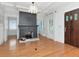 Bright living room with hardwood floors and black painted brick fireplace and mantle at 1405 Nance Ave, Tampa, FL 33606