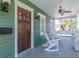 Inviting front porch with fan, sconces, and a dark wood front door at 1405 Nance Ave, Tampa, FL 33606