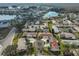 Aerial view of a charming home nestled within a quiet neighborhood with a nearby lake at 1809 Atrium Dr, Sun City Center, FL 33573