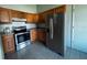 Well-equipped kitchen featuring stainless steel appliances, wooden cabinets, and tile flooring at 18231 Steele Ave, Port Charlotte, FL 33948