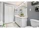 Elegant bathroom with double sinks, white marble floors, and ample storage at 1925 Tidewater Ct, Wesley Chapel, FL 33543