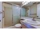Bathroom with a glass enclosed shower, toilet, and large vanity with mirror at 19701 Gulf Blvd # 328, Indian Shores, FL 33785