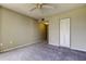 Bedroom with wall to wall carpeting, neutral paint, closet, and a ceiling fan at 19701 Gulf Blvd # 328, Indian Shores, FL 33785