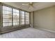 Bedroom with large window, plush carpet, and neutral walls with a ceiling fan at 19701 Gulf Blvd # 328, Indian Shores, FL 33785