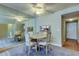 Cozy dining room with a ceiling fan, mirrored wall and a view of the kitchen at 19701 Gulf Blvd # 328, Indian Shores, FL 33785