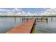 Beautiful waterfront property featuring a private wooden dock and a kayak at 19701 Gulf Blvd # 328, Indian Shores, FL 33785