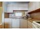 Corner view of a kitchen featuring white appliances, under-cabinet lighting, and double sink at 19701 Gulf Blvd # 328, Indian Shores, FL 33785