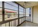 Enclosed lanai with tile flooring and windows overlooking the complex pool and water views at 19701 Gulf Blvd # 328, Indian Shores, FL 33785