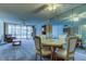 Open-plan living area with a large mirror, cozy seating, and a view of the lanai at 19701 Gulf Blvd # 328, Indian Shores, FL 33785