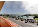 View of a parking lot facing the intercoastal waterway with boat docks and sunny skies at 19701 Gulf Blvd # 328, Indian Shores, FL 33785