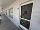 Exterior of condo entrance with protective screen door; unit is number 56 at 2100 World Parkway Blvd # 56, Clearwater, FL 33763