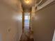 Hallway with tile flooring and neutral paint leading to the living room at 2100 World Parkway Blvd # 56, Clearwater, FL 33763