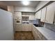 Charming vintage kitchen with white appliances and ample cabinet space; needs some updating at 2100 World Parkway Blvd # 56, Clearwater, FL 33763