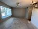 Bright living room with large window and vintage ceiling fan; needs renovation at 2100 World Parkway Blvd # 56, Clearwater, FL 33763