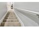 Carpeted staircase with white railing leads to the upper level of the home at 2110 Wolfskill Pl, Riverview, FL 33578