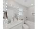 Modern bathroom featuring a vanity with a lighted mirror and a shower/tub combo at 2302 Village Amble Loop, Lutz, FL 33558