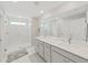 Double vanity bathroom with a large walk-in shower at 2302 Village Amble Loop, Lutz, FL 33558