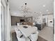 Modern dining area with white table and chairs, open to kitchen at 2302 Village Amble Loop, Lutz, FL 33558