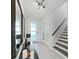 Bright and airy entryway with tile flooring and modern staircase at 2302 Village Amble Loop, Lutz, FL 33558