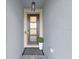 Modern entryway with dark gray door, and a black and white striped rug at 2302 Village Amble Loop, Lutz, FL 33558