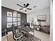 Modern home office with dark accent wall, desk, and a chevron patterned rug at 2302 Village Amble Loop, Lutz, FL 33558
