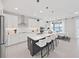 Modern white kitchen with large island, stainless steel appliances, and white cabinetry at 2302 Village Amble Loop, Lutz, FL 33558