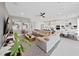 Open concept living room with sectional sofa and kitchen view at 2302 Village Amble Loop, Lutz, FL 33558