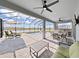 Relaxing pool area with screened enclosure, outdoor kitchen, and ample seating at 2302 Village Amble Loop, Lutz, FL 33558