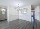 Dining room with dark grey floors, wainscotting and modern light fixture at 2460 Canadian Way # 64, Clearwater, FL 33763