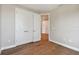 Bedroom with hardwood floors, featuring a double door closet at 3022 W Cass St, Tampa, FL 33609