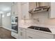 Modern kitchen featuring stainless steel appliances, white cabinets and marble countertops at 3022 W Cass St, Tampa, FL 33609