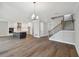 Open concept living space with wood floors, kitchen, and staircase at 3022 W Cass St, Tampa, FL 33609