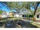 Backyard with a table and chairs set, fire pit, storage shed, and mature trees offering plenty of shade at 3621 S Belcher Dr, Tampa, FL 33629