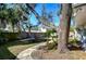 Secluded backyard featuring mature trees, landscaping, and a stone patio area at 3621 S Belcher Dr, Tampa, FL 33629