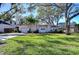 Charming single-story home featuring a lush green lawn and mature shade trees at 3621 S Belcher Dr, Tampa, FL 33629