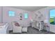 Bedroom room with a crib, a comfortable chair, and soft pink accents at 36424 Sespe Creek Ct, Zephyrhills, FL 33540