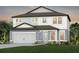 Two-story home featuring a neutral color palette, two car garage, and a well manicured lawn at 36424 Sespe Creek Ct, Zephyrhills, FL 33540