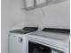 Laundry room with washer, dryer, and a wire shelf for storage at 36424 Sespe Creek Ct, Zephyrhills, FL 33540