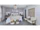 Comfortable main bedroom with a chandelier, large bed, and stylish decor at 36424 Sespe Creek Ct, Zephyrhills, FL 33540