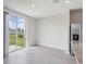 Bright dining area with sliding glass doors to the backyard and gray wood-look tile flooring at 3827 Radiant Mountain Dr, Plant City, FL 33565