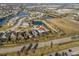 Neighborhood aerial view showing the house with pond, golf course, and community amenities at 4509 Golden Gate Cv, Bradenton, FL 34211
