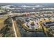Aerial view of a house in a community with pond and golf course views at 4509 Golden Gate Cv, Bradenton, FL 34211