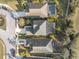 An aerial view shows the roof lines, driveways, and screened-in pools in this Florida neighborhood at 4509 Golden Gate Cv, Bradenton, FL 34211