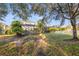 Serene backyard with mature trees and a screened-in pool area for relaxation at 4509 Golden Gate Cv, Bradenton, FL 34211